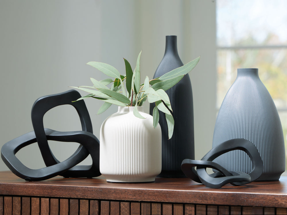 Give your space a contemporary vibe and lots of variety with this accessory set. These vases and sculptures, with a medley of neutral hues that work in beautiful harmony, mix well with your existing decor. Displayed in a group or individually, their uniqu