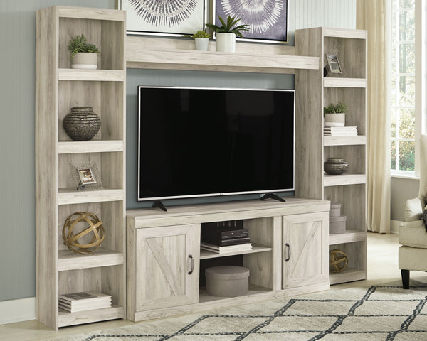 Express your modern farmhouse style with this entertainment center. Its wispy white finish over replicated oak grain is a delightful change from the ordinary. Clean-lined, classic styling with barn door inspiration provides a country-chic aesthetic thatâ€