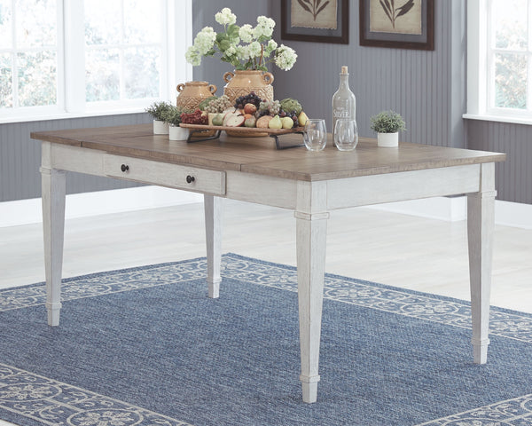 Set the scene for coastal chic or modern farmhouse living with this dining room table. Clean-lined, simply striking table doubles the charm with a brown tone top with plank effect, paired with a grayish white base with rub through effect for timeworn appe