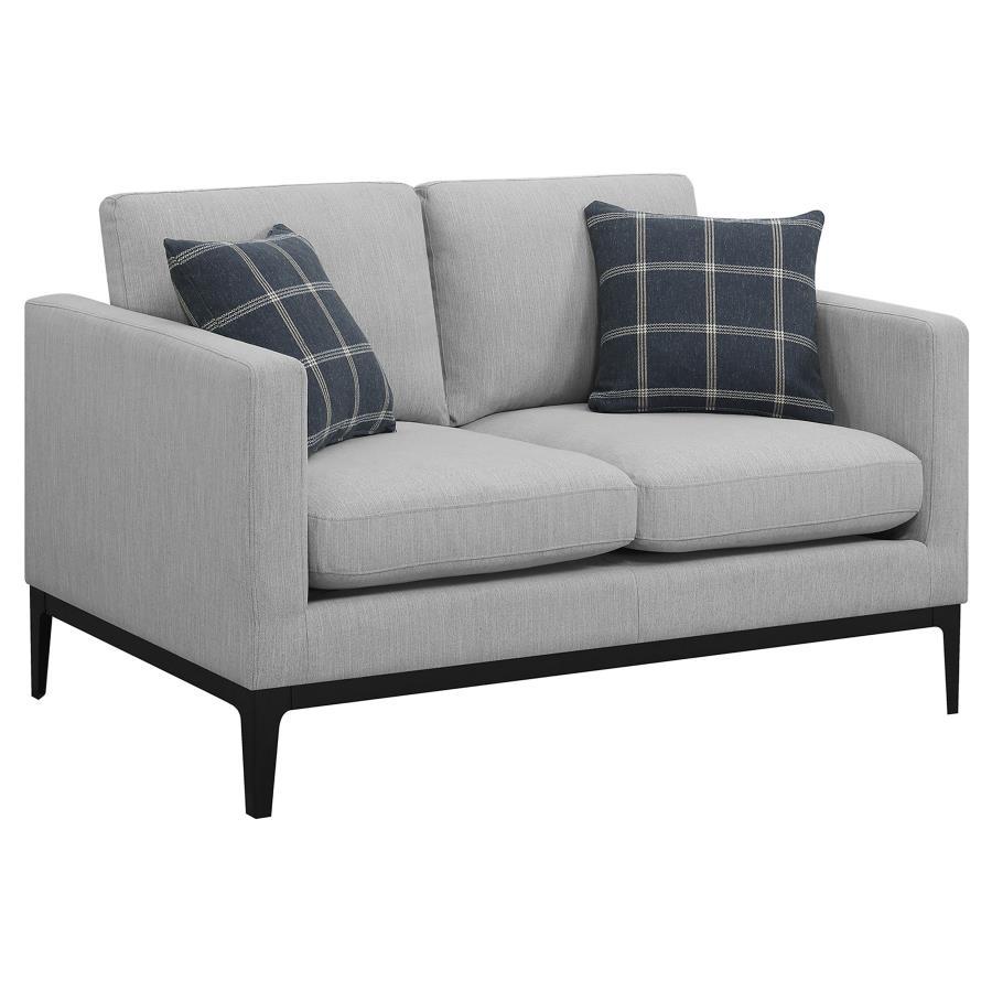 This loveseat is the ultimate in casual comfort. With a soft, plush back and seat cushions, it offers hours of soothing relaxation. Its lovely, muted shade of light grey blends effortlessly with a variety of color palettes. Two dark accent pillows with a 