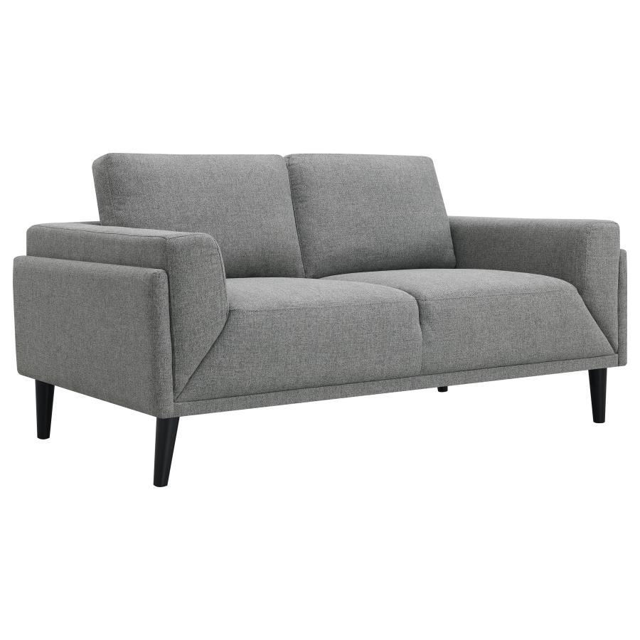 Unveiling our modern loveseat, where innovation meets elegance in a frame within a frame design. Adorned in a chic fabric, its streamlined silhouette is highlighted by meticulous topstitch details and track arms complemented by mitered front accents. Prio