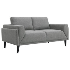 Unveiling our modern loveseat, where innovation meets elegance in a frame within a frame design. Adorned in a chic fabric, its streamlined silhouette is highlighted by meticulous topstitch details and track arms complemented by mitered front accents. Prio