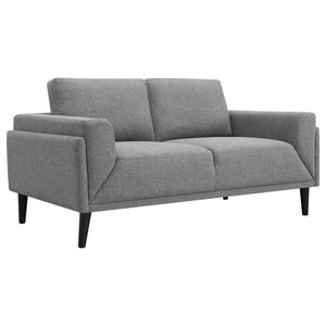 Unveiling our modern loveseat, where innovation meets elegance in a frame within a frame design. Adorned in a chic fabric, its streamlined silhouette is highlighted by meticulous topstitch details and track arms complemented by mitered front accents. Prio