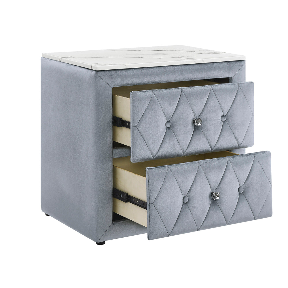 This elegant nightstand brings a touch of luxury to any bedroom with its rich, velvety texture and diamond-patterned tufting. The soft, plush exterior is complemented by gleaming crystal-like drawer knobs, adding a hint of glamour. With two spacious drawe