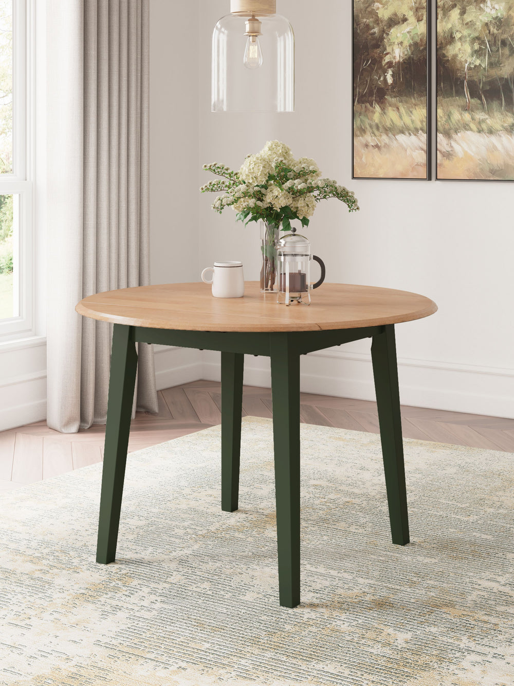 Complement your homeâ€™s simply relaxed sensibility with this drop-leaf dining table. A charming green hue offers a chic contrast to the natural wood tone, for a casual look that vibes with a variety of aesthetics. When guests drop by, convert it from a s