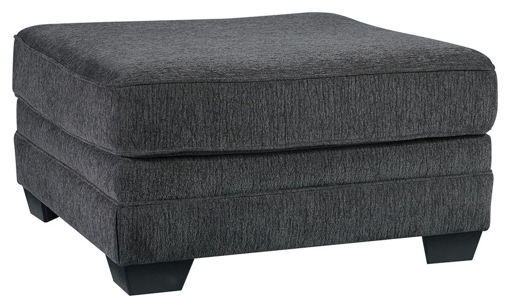 The ultimate sectional centerpiece, this oversized ottoman is big on cool, contemporary style and long on comfort. Plushly upholstered in a slate gray fabric, this ottoman is so generously scaled, you can top it with a serving tray and still have plenty o