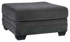 The ultimate sectional centerpiece, this oversized ottoman is big on cool, contemporary style and long on comfort. Plushly upholstered in a slate gray fabric, this ottoman is so generously scaled, you can top it with a serving tray and still have plenty o