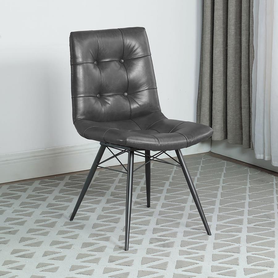 Blending mid-century modern aesthetics with everyday comfort, this dining side chair is a stylish addition to any dining space. Upholstered in charcoal faux leather, its gently curved tufted seat and backrest offer a supportive and inviting feel. Angled m