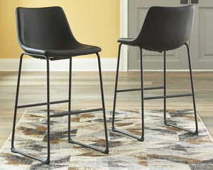 With its distinctive contoured bucket seat and tubular metal base, this bar stool serves up a fresh twist on mid-century inspired style. Faux leather upholstery in French black adds to the indulgence. What a timeless look for eat-in kitchens and casually 