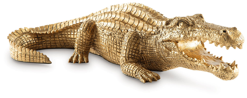 This sculpture brings a glam appeal to wild style. Luxe in an antiqued goldtone finish, the alligator-shaped art piece is a snappy addition to your office or living room decor. Its remarkable attention to detail captures the animal-'s likeness in decidedl
