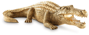 This sculpture brings a glam appeal to wild style. Luxe in an antiqued goldtone finish, the alligator-shaped art piece is a snappy addition to your office or living room decor. Its remarkable attention to detail captures the animal-'s likeness in decidedl