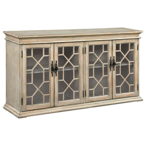 Add rustic charm and timeless elegance to your home with this farmhouse-inspired accent cabinet. A warm honey-toned finish and weathered detailing give it a country-style appeal, while decorative glass panel doors with intricate trim add a refined touch. 