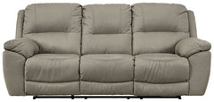 Kick back, relax, and enjoy some sports on TV with this reclining sofa. You will love its double stuffed pillow top arms and soft-as-suede faux leather upholstery. The family-friendly dark gray color and creative stitching add panache. Recline in comfort 