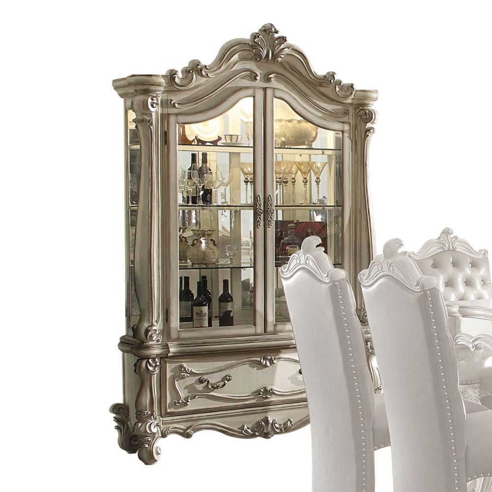 Curio Cabinet Arched Top: Touch Light & 2 Glass Doors (3 Glass Shelves & Back Mirror Inside) Base: 1 Drw Oversized Scrolled Trim, Leaf Crown and Post-Leg (Poly Resin with Antique Contrast Finish) Drawer: GLIDE Side Metal, DT French, Felt-Lined Included<br