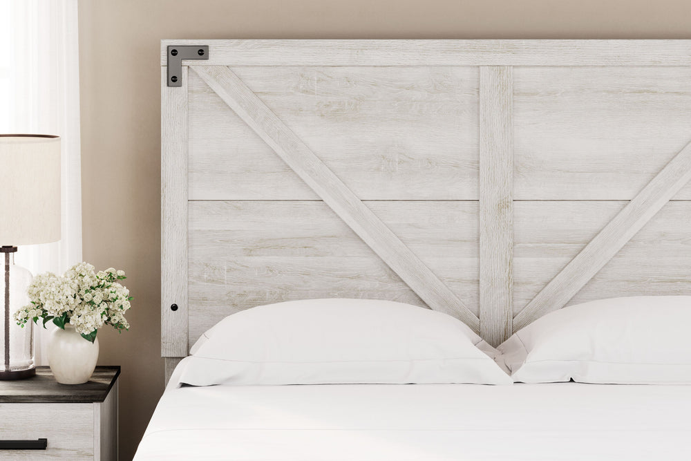 Give provincial a new meaning with the chic look of this queen panel headboard. The white wash distressed finish keeps this piece light and fresh while the warm pewter-tone hardware adds an industrial touch. The panel headboard with crossbuck detail adds 
