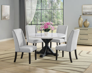 A fresh take on a traditional silhouette makes this group a great addition to your dining space. A genuine marble top is luxurious and timeless. Farmhouse style cross legs are updated in a contemporary charcoal finish. The upholstered dining chairs featur