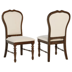 Complement your chic dining ensemble with a set of two traditional dining side chairs. Each boasts durable construction in Asian hardwood, complete with a rich brown finish. Chairs are designed with decorative rounded backs, framed in wood to create defin