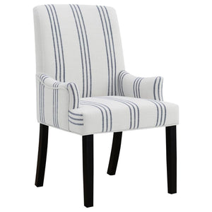 This armchair adds a refined yet relaxed charm to your dining space, blending comfort with casual elegance. Upholstered in linen-like beige fabric with blue stripes, it offers a timeless aesthetic. The padded seat, backrest, and gracefully curved arms ens