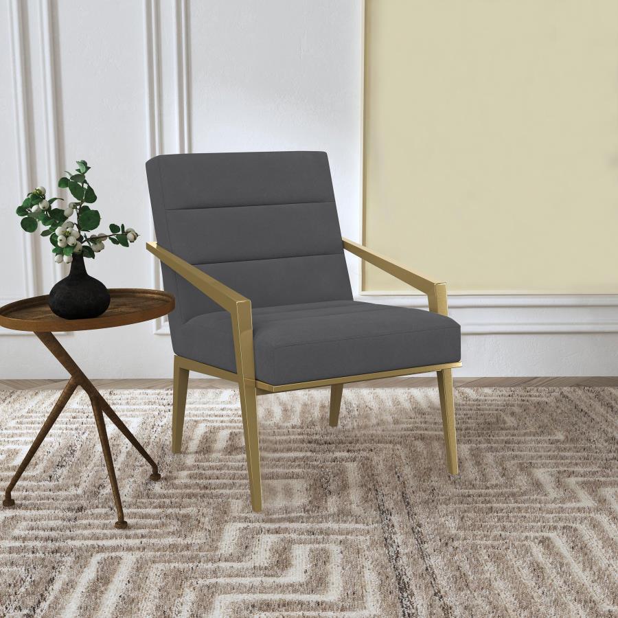 Restrained, modern style meets elegant artistry in a striking contemporary armchair. Designed to stand out, it boasts an upholstered seat and back with a metal frame and arms. The streamlined look receives a gleaming gold finish, adding sophistication any