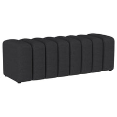 Introduce glam texture and dimension with a decorative upholstered bench. This modern creation features an undulating silhouette without arms or a back, offering sleek style and seating. Perfect for a sophisticated foyer or living room, it adds a pop of c