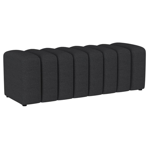 Introduce glam texture and dimension with a decorative upholstered bench. This modern creation features an undulating silhouette without arms or a back, offering sleek style and seating. Perfect for a sophisticated foyer or living room, it adds a pop of c