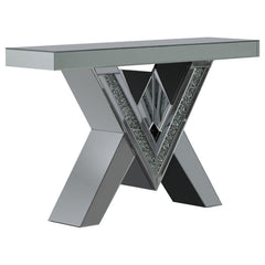 This mirrored console table boasts a striking V-shaped base with angular design elements, featuring inlays of sparkling acrylic crystals. The geometric form is complemented by sleek mirrored surfaces that enhance its modern aesthetic. The design combines 