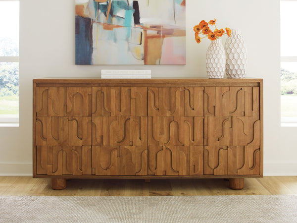 this accent cabinet is a work of art. From the geometric cutout pattern on the door fronts to the beautiful honey brown finish