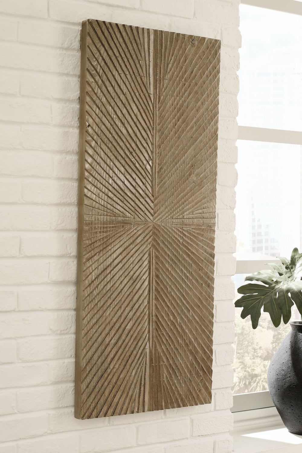 Sure to warm your space with a touch of rustic refinement, this wall sculpture is a natural wonder. Showcasing a sunburst design and finished in a distressed brown for a sense of organic beauty, this piece grounds your space with its modest take on textur