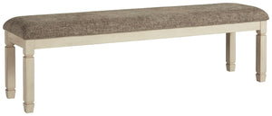 The beauty of this upholstered dining bench is something to savor. Serving up country cottage comfort and fresh farmhouse flair, the generously-scaled bench entices with a cushioned seat covered in a heavy woven fabric that complements the trendy textured