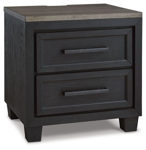 This nightstand is casual contemporary style simply done right. Its two-tone color scheme features a rich brushed black main color accented with a beautiful dusty grayish brown wood tone. Two drawers with sleek black pulls offer plenty of storage for your