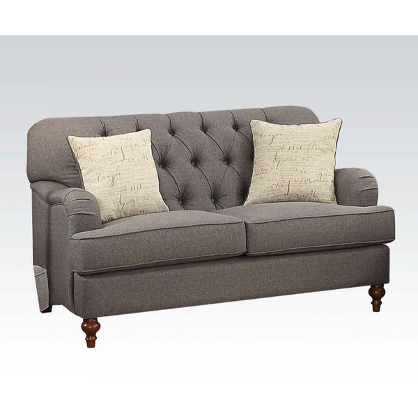 The Alianza loveseat is an ideal choice for any living room. This loveseat features a diamond tufted backrest, tight back and loose seat cushions. The dark gray fabric with brown wooden bun legs in the front and wooden legs , alongside the English curved 