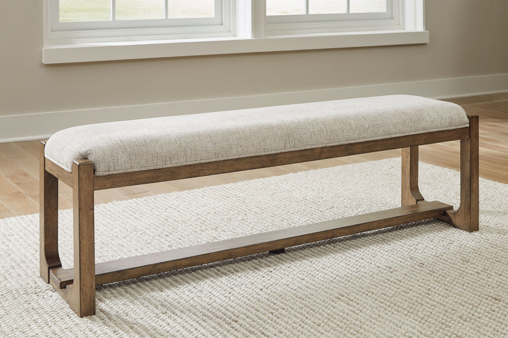 This dining bench sits comfortably at the intersection of modern lodge and farmhouse aesthetics. Your warm and welcoming disposition is reflected in its charming architectural elements and neutral textural fabric. Even with its poise, the bench remains pr
