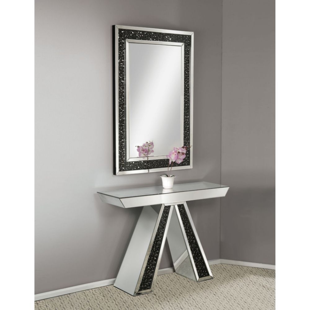 The gorgeous Noor mirrored console table is a great addition to your foyer or living room. This table is a sight with its rectangular mirror top with a unique geometric base that is a combination of regular mirror and black decorative crystal center. Shin