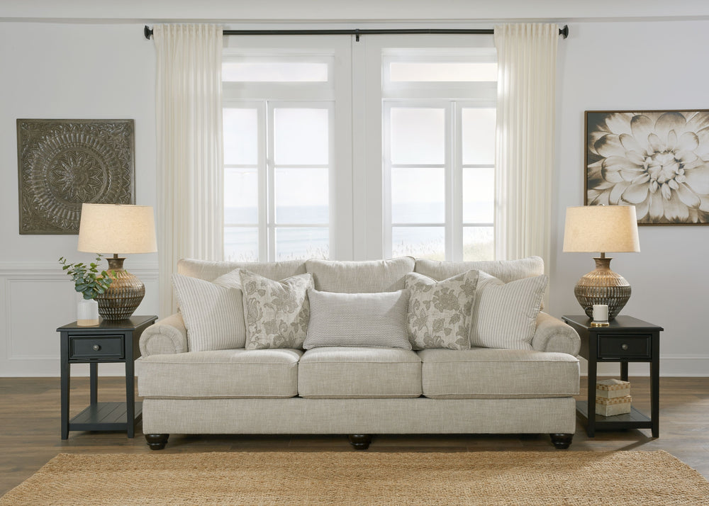 This sofa has an alluring look that-'s guaranteed to turn heads. Richly textured fabric in a light, easygoing hue is enhanced by even lighter flax peeking through. Distinctive roll arms add a dab of debonair, while indulgently plush cushions cradle you so