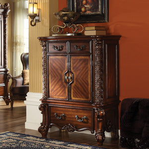 Create an elegant, traditional design in your bedroom with the cherry Vendome chest. This hand-crafted piece inspired from the luxurious designs of the past, this three-drawer, two-door chest features elaborate wood carving details, traditional hardware a