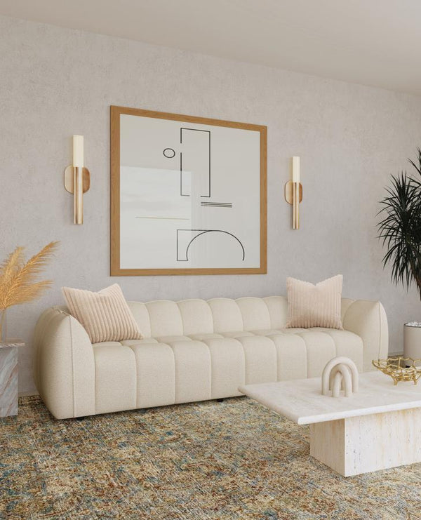  a perfect interior focal point with its fun bubble-like design. The sofa shows off boucle upholstery in a sand pebble hue