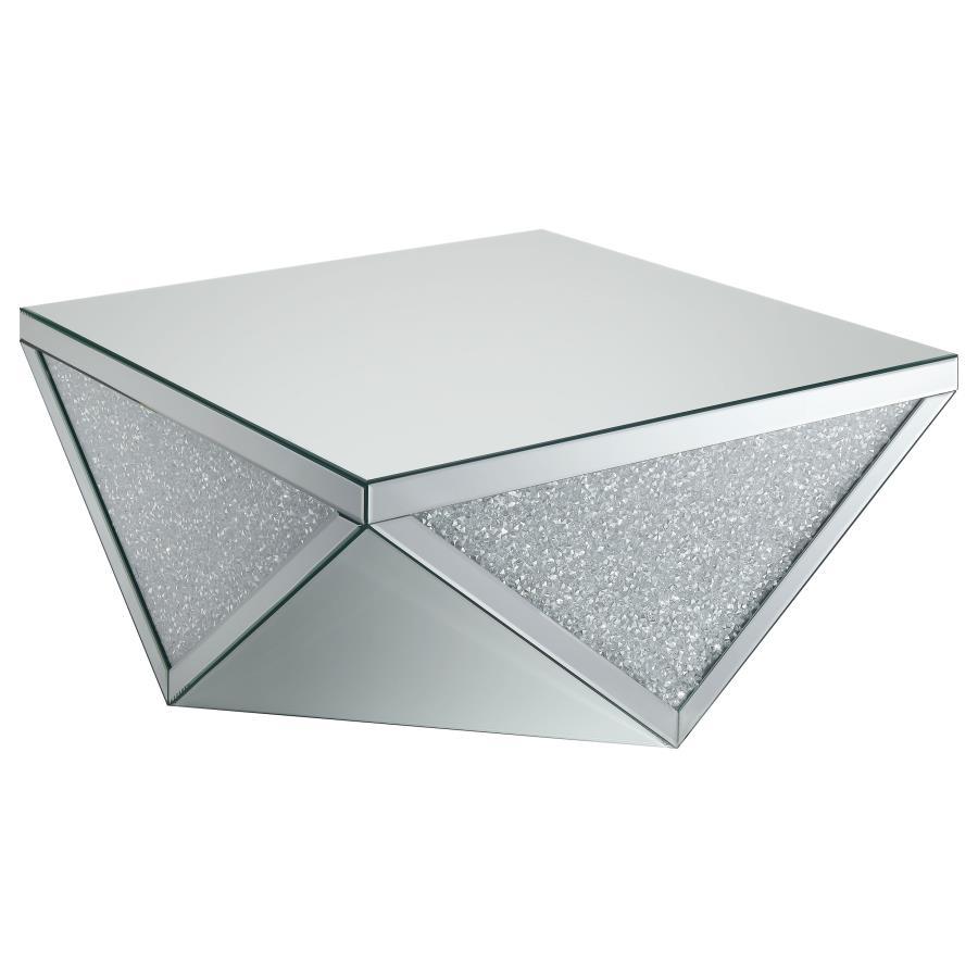 Amplify the style of your living room with this mirrored coffee table. Its bold, diamond-shaped base features triangular mirrored panels with alternating glittery material, adding shimmering sparkle and opulent style. A 40-inch square, reflective surface 
