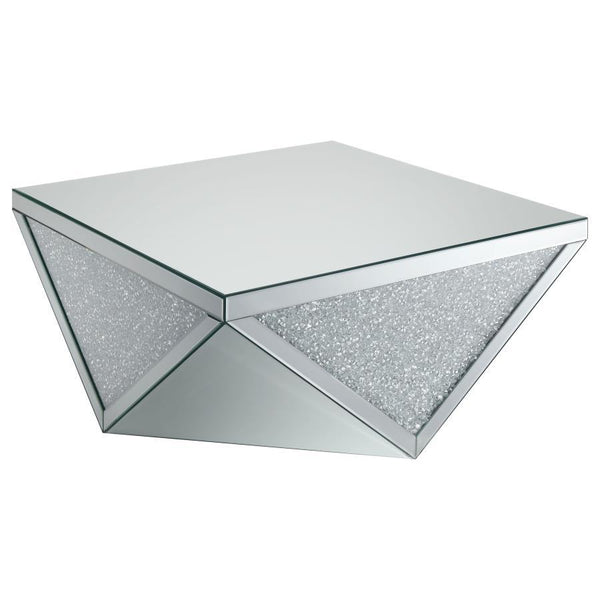 Amplify the style of your living room with this mirrored coffee table. Its bold, diamond-shaped base features triangular mirrored panels with alternating glittery material, adding shimmering sparkle and opulent style. A 40-inch square, reflective surface 
