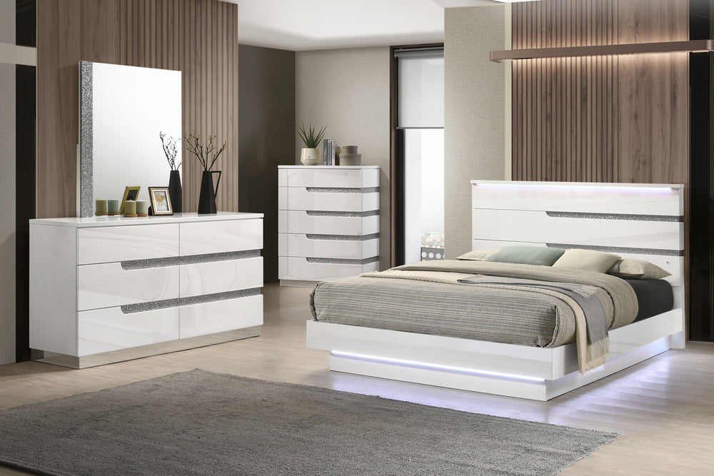 The Paradox 4 Piece Platform Bedroom Set in White is a stunning combination of contemporary style and functional elegance. This set includes a platform bed along with a dresser, mirror, and chest. The gleaming white gloss laminate finish offers a sleek, m