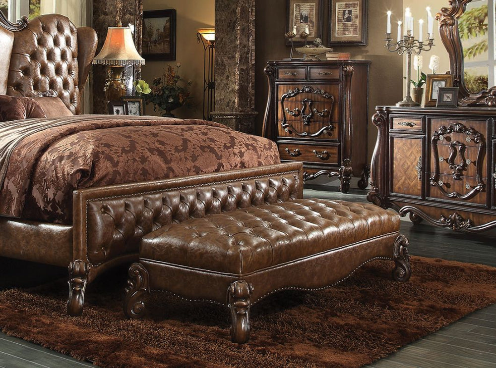 The Versailles Bench presents a hand-crafted piece inspired by the most luxurious designs of the past. The stunning PU upholstered ottoman comes in a cherry finish and features a two tone, light brown, button-tufted seat. Nailhead trim accent and elaborat