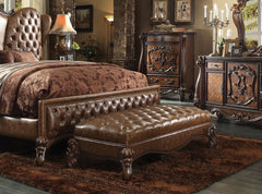 The Versailles Bench presents a hand-crafted piece inspired by the most luxurious designs of the past. The stunning PU upholstered ottoman comes in a cherry finish and features a two tone, light brown, button-tufted seat. Nailhead trim accent and elaborat