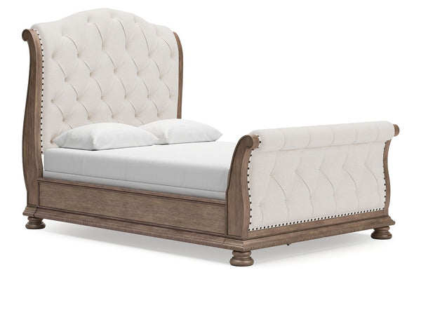 Merging traditional elegance with modern comfort, this queen upholstered sleigh bed takes your bedroom retreat to the next level. It radiates timeless sophistication with its shapely curves, glazed antiqued-look finish and tufted cushions. Talk about stun