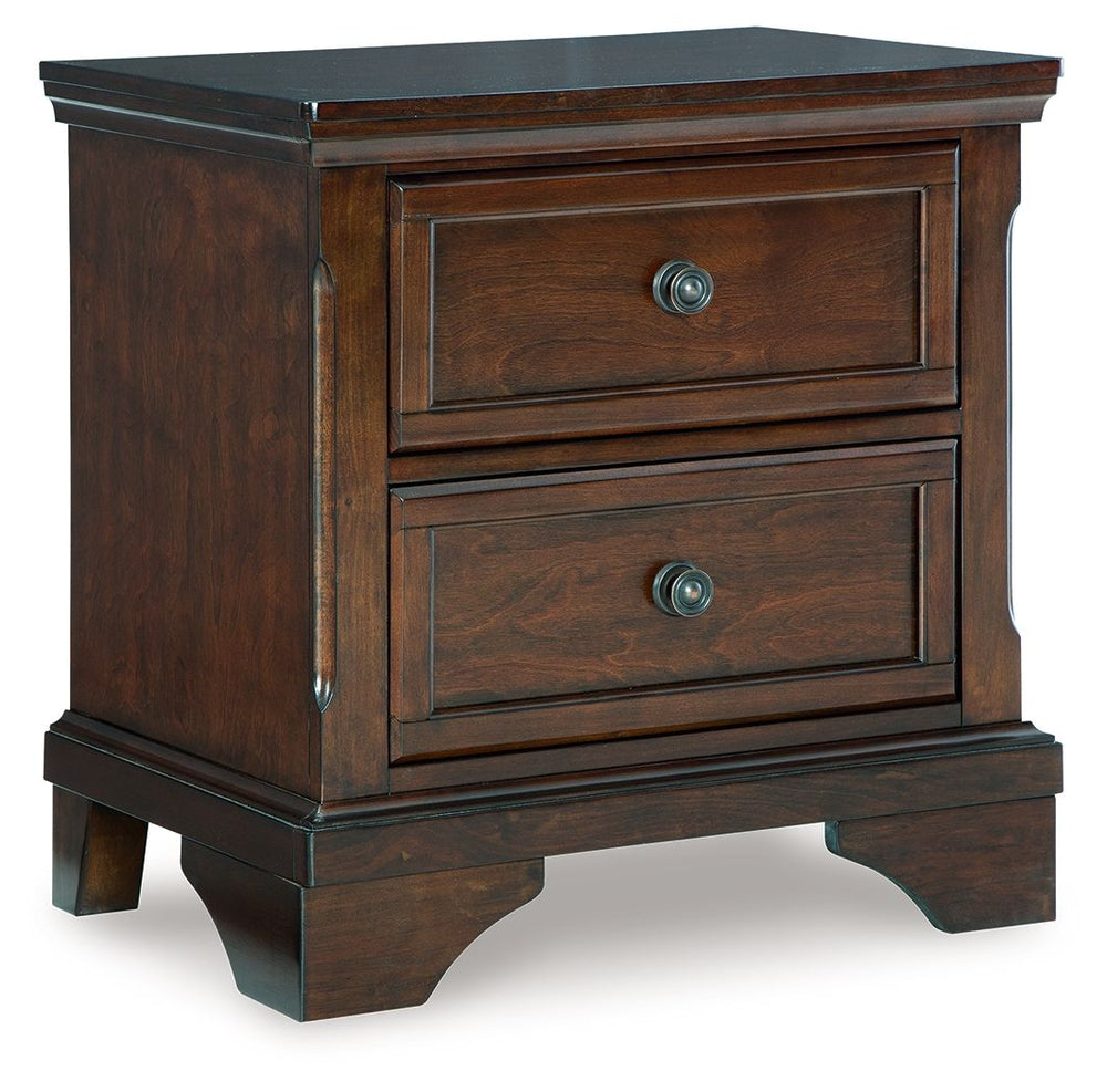 This nightstand has a timeless look and traditional design that dresses up your bedside area. Its warm brown cherry finish adds a casual classic aesthetic, while round metal knobs in a dark bronze tone create a beautiful focal point on two stylishly subtl