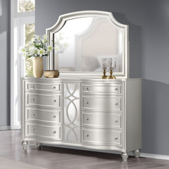 This Reflections Dresser and Mirror Set effortlessly combines form and function with its long-lasting construction, expertly crafted from solid Pine and premium manufactured wood, ensuring it stands the test of time. The glamorous matte silver finish adds
