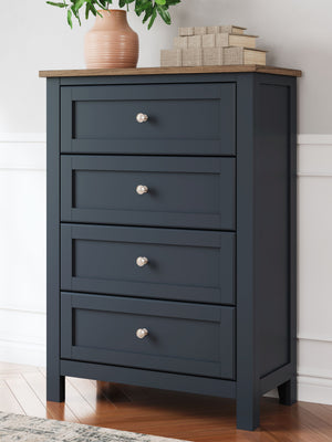  this chest of drawers pairs a dark slate blue finish with a light brown top. Drawer fronts and legs in a classic Shaker style bring an air of beautiful simplicity to the b