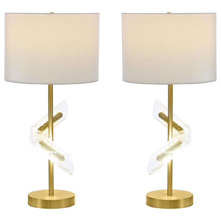 Designed to dazzle, this pair of gold table lamps features a clean drum shade paired with sculptural acrylic accents that wrap around the slender frame. A brilliant LED light glows from within the swirling acrylic, bringing dimension and ambient lighting 