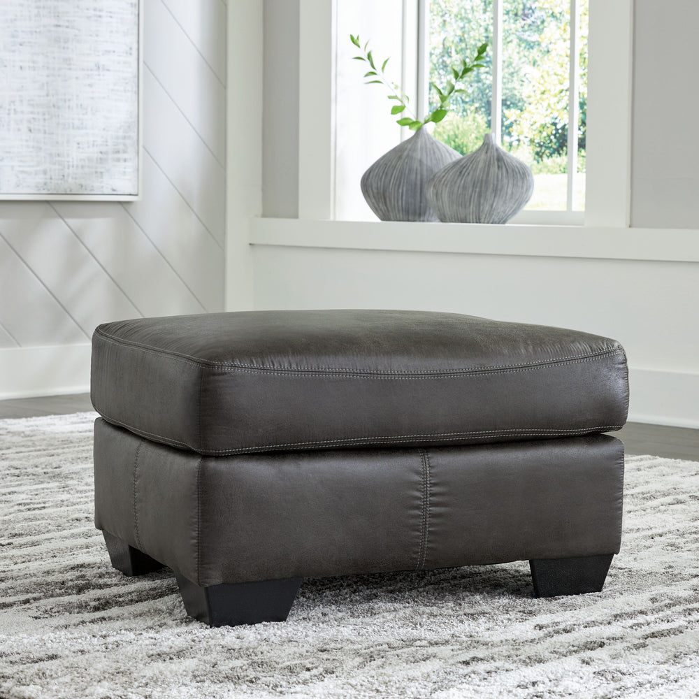 If you love the cool look of leather but long for the warm feel of fabric, you-'ll find this ottoman fits the bill beautifully. Enhancing its handsome profile and generous scale: a textural, multi-tonal upholstery thatâ€™s loaded with character and intere