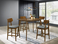 Create a warm and inviting breakfast nook with this charming five-piece modern counter height dining set. Centering on a 47-inch table, it boasts a rich walnut finish that lends timeless character and style. The table boasts angled fin-style legs that add