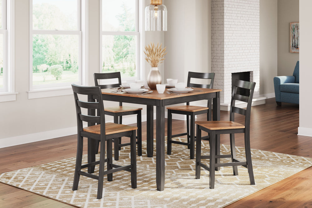 Who says a simple design can-'t be eye-catching? This counter height dining table with bar stools has a casually cool style, yet it still turns heads. The two-tone table and bar stools are effortlessly handsome. And the ladderback bar stools cater to your