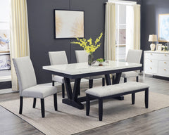 A fresh take on a traditional silhouette makes this group a great addition to your dining space. A faux marble top provides an elegant look while being easy to care for. The trestle base is updated in a contemporary charcoal finish. The upholstered dining